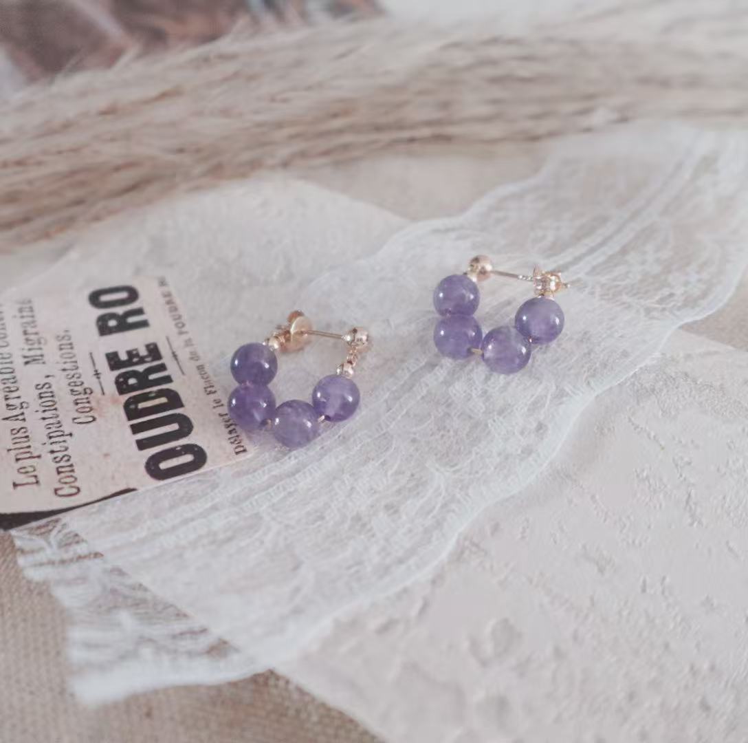 Amethyst Bead Stud Earrings featuring sparkling purple beads and elegant gold accents