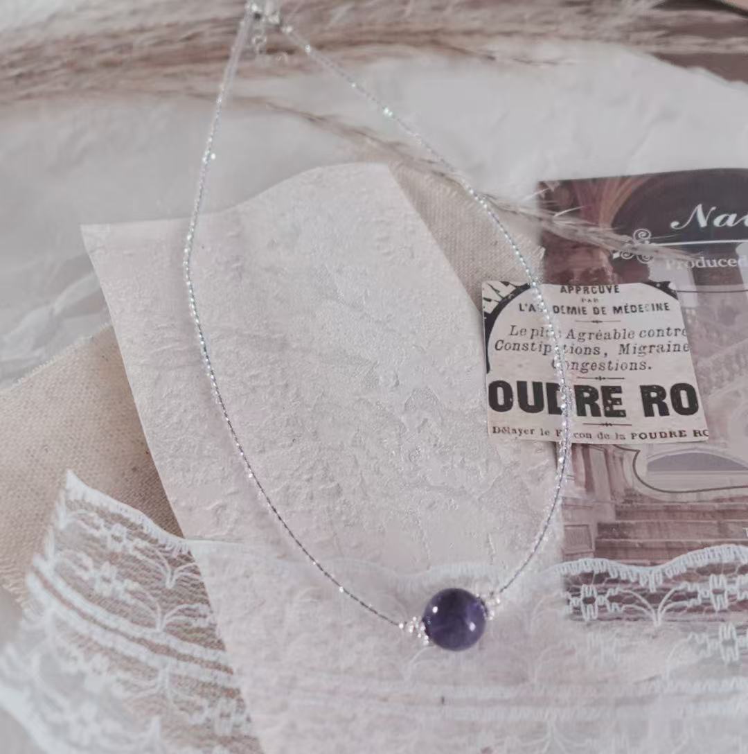 Elegant Amethyst Beaded Necklace featuring a unique purple crystal centerpiece on a delicate silver chain