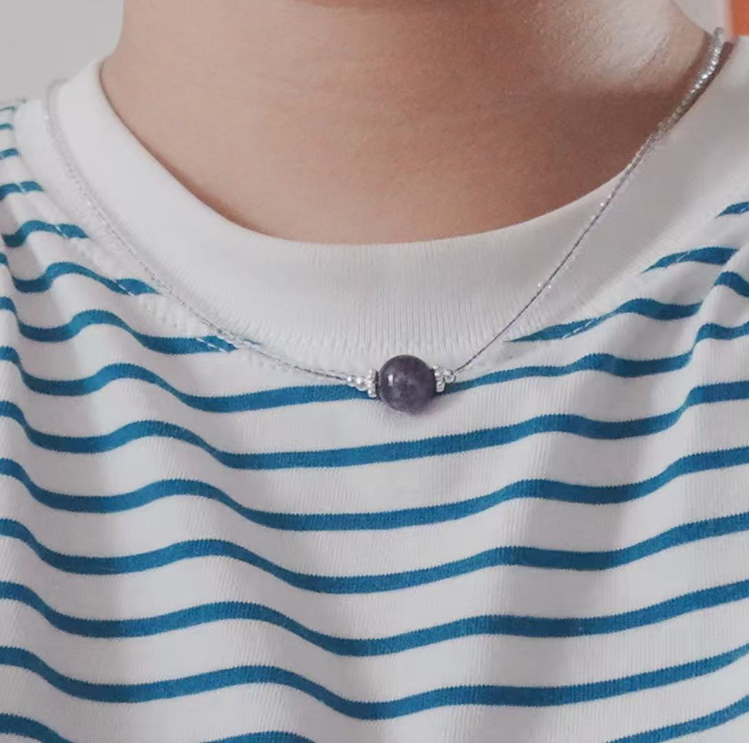 Close-up of Amethyst Beaded Necklace worn on a striped shirt, showcasing its elegant design.