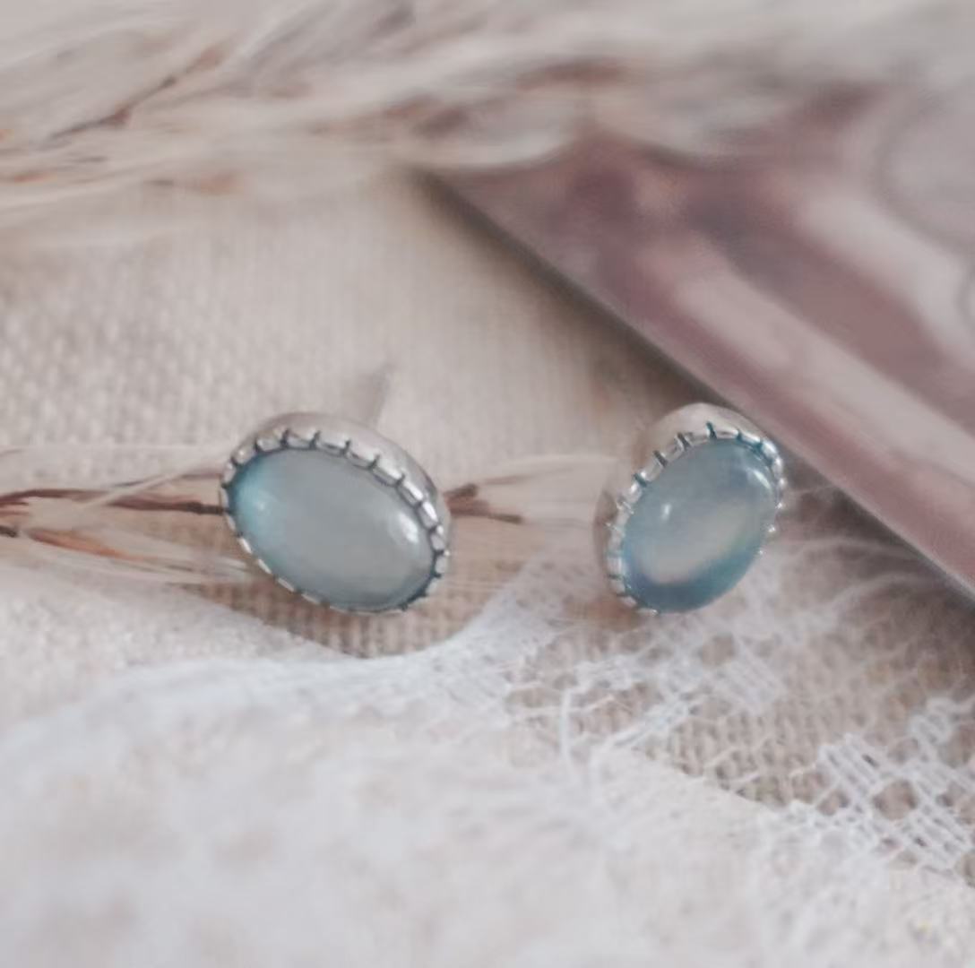 Aquamarine Oval Stud Earrings set in silver, showcasing a serene blue hue for elegant style