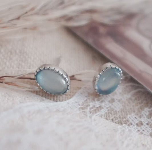 Aquamarine Oval Stud Earrings set in silver, showcasing a serene blue hue for elegant style