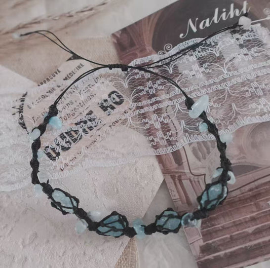 Blue Apatite Woven Bracelet with delicate blue crystals on a black cord, ideal for a stylish accessory