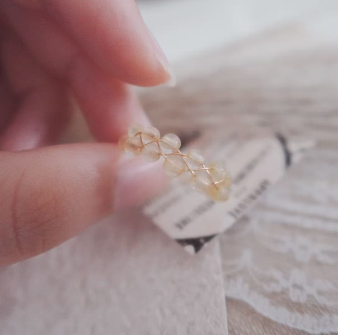 Citrine Bead Ring showcasing a delicate design with natural crystals and gold accents in hand