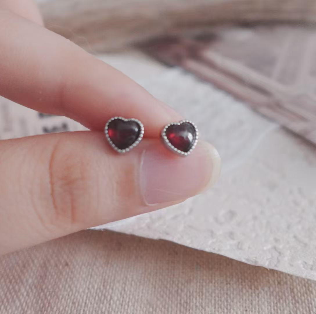 Garnet Heart Stud Earrings with a delicate silver setting, perfect for everyday wear or special occasions