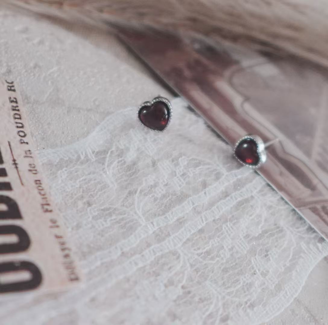 Garnet Heart Stud Earrings beautifully designed with a polished finish, perfect for elegant occasions