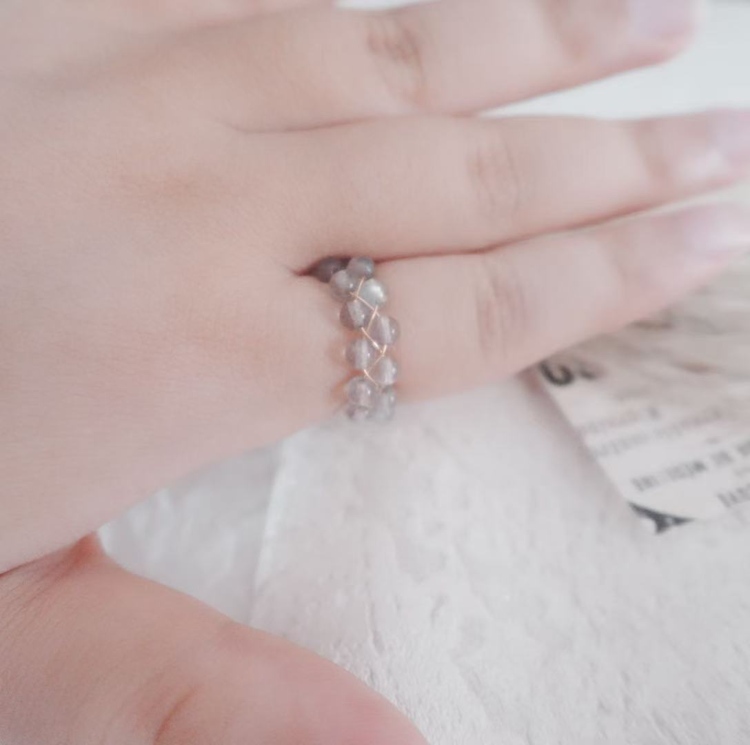 Elegant Labradorite Bead Ring on a hand with a delicate design showcasing shimmering colors
