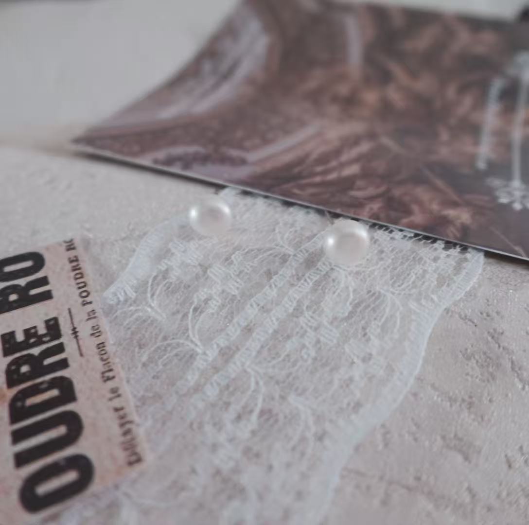 Natural Freshwater Pearl Oval Stud Earrings displayed on lace background with elegant magazine