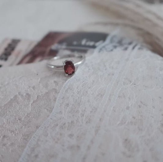 Elegant Oval Garnet Ring set in silver, showcasing a rich red gemstone for a timeless look