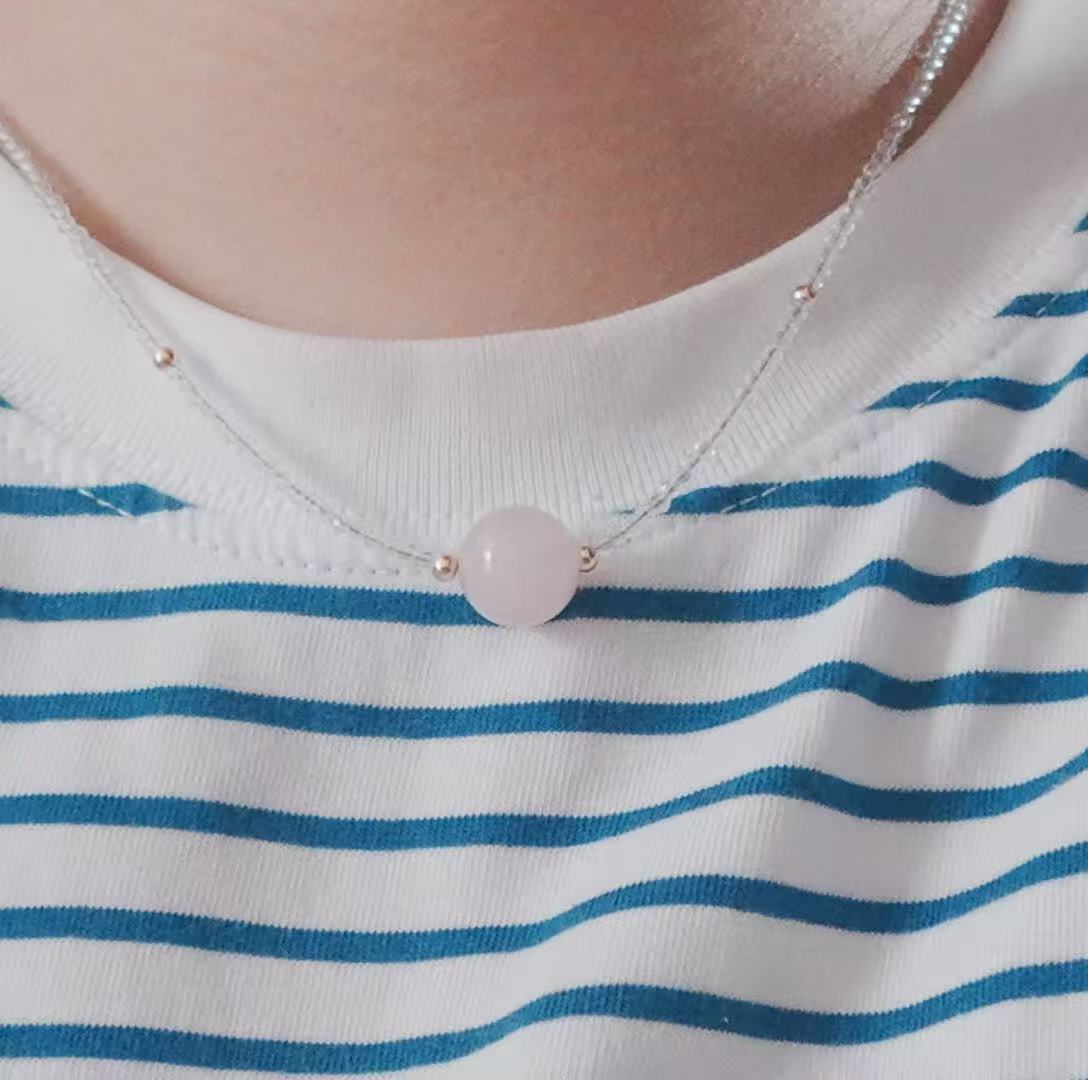 Elegant Rose Quartz Beaded Necklace with a smooth pink stone centerpiece on a silver chain