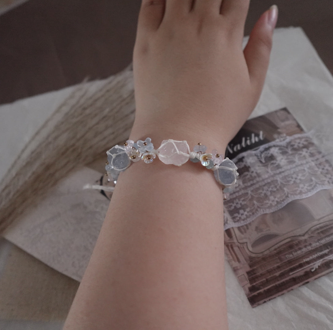 Rose Quartz & Blue Crystal Woven Bracelet showcased on a hand with stylish backdrop