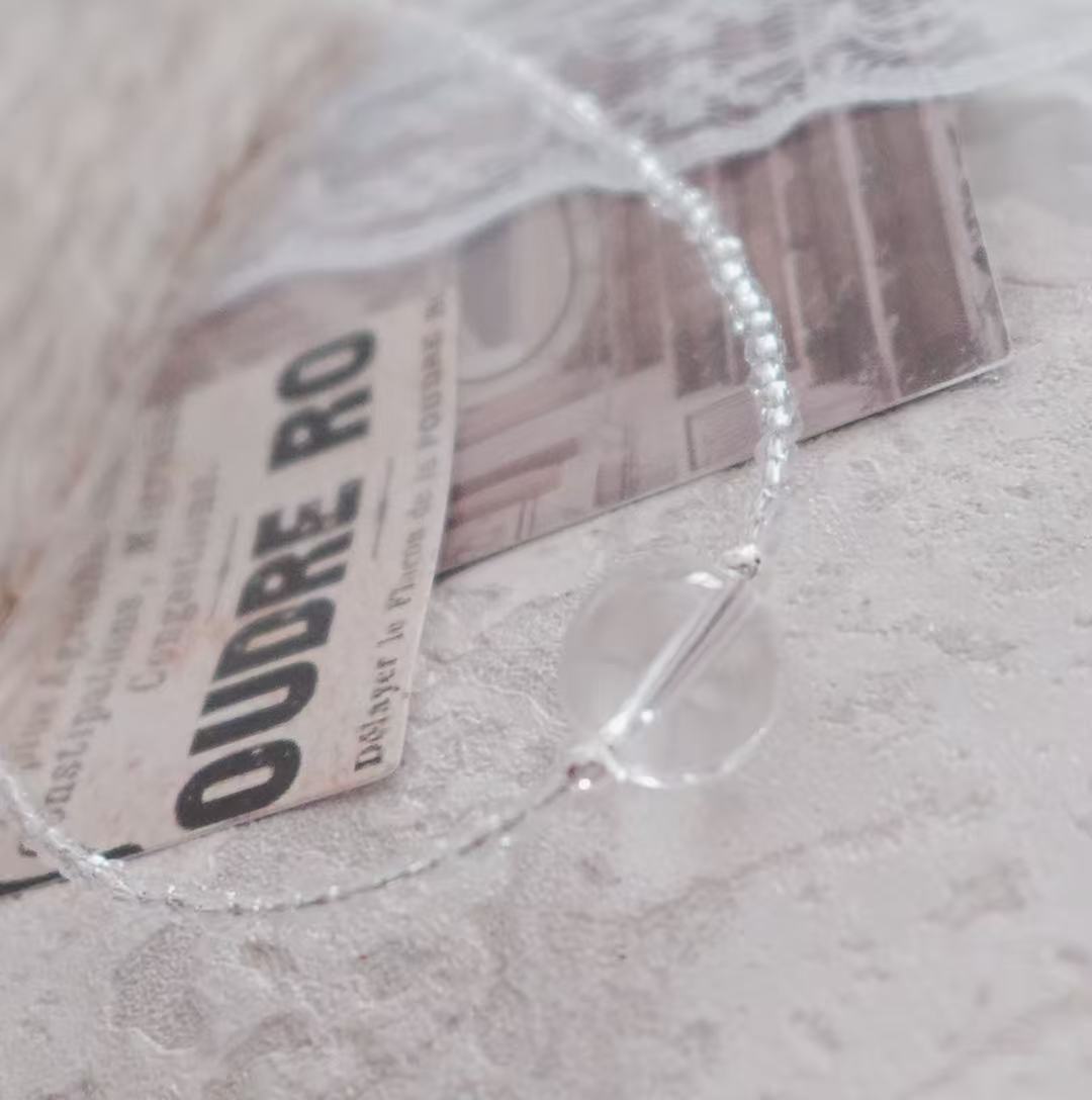 Elegant White Crystal Beaded Necklace on a textured background showcasing its unique shine