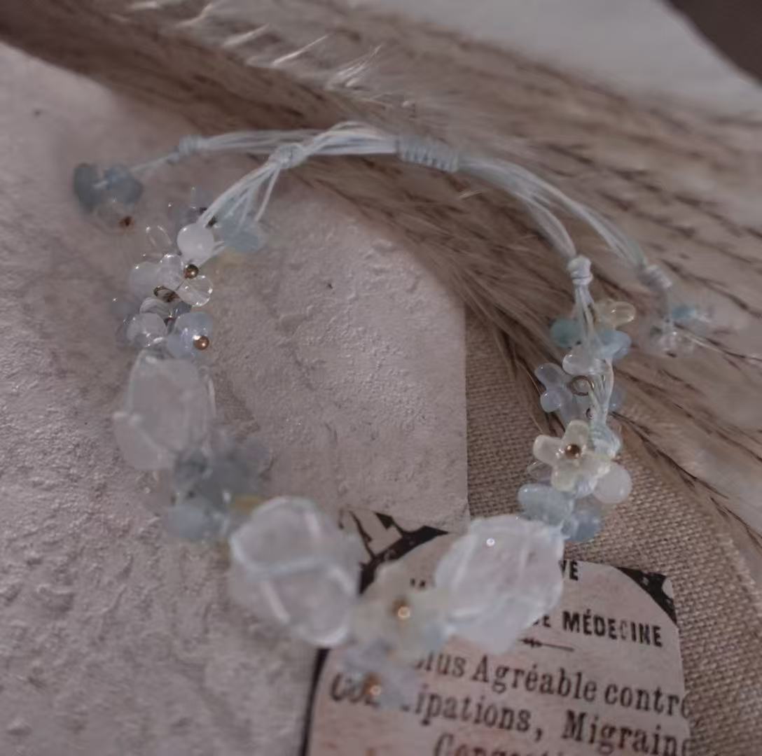 Delicate White Crystal Woven Bracelet adorned with light blue and clear beads for a stylish accessory