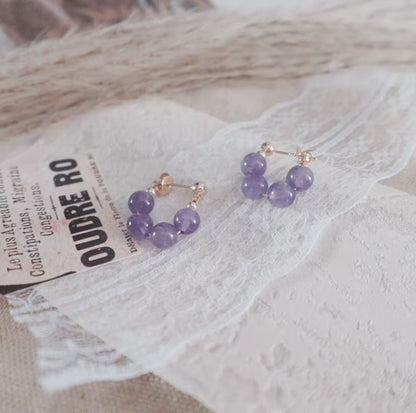Amethyst Bead Stud Earrings featuring sparkling purple beads and elegant gold accents