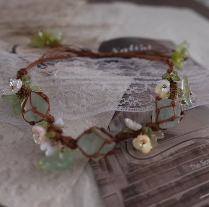 Green Fluorite Woven Bracelet featuring natural crystals and unique floral designs on a brown cord