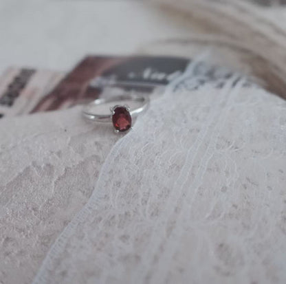 Elegant Oval Garnet Ring set in silver, showcasing a rich red gemstone for a timeless look